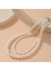 Huitich double layer pearl choker necklace with two strands of white pearls on beige background