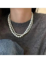 Double-layer pearl choker necklace with graduated pearls at the neckline