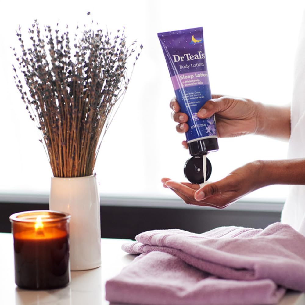 Dr Teals sleep lotion with melatonin being poured into hands next to lavender candle and folded towels