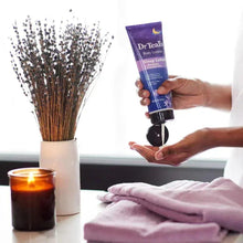 Hand holding DrTeal's sleep lotion tube
