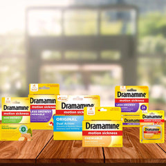 Assortment of Dramamine chewable and less drowsy packs on a wooden table Dramamine motion sickness relief for children.