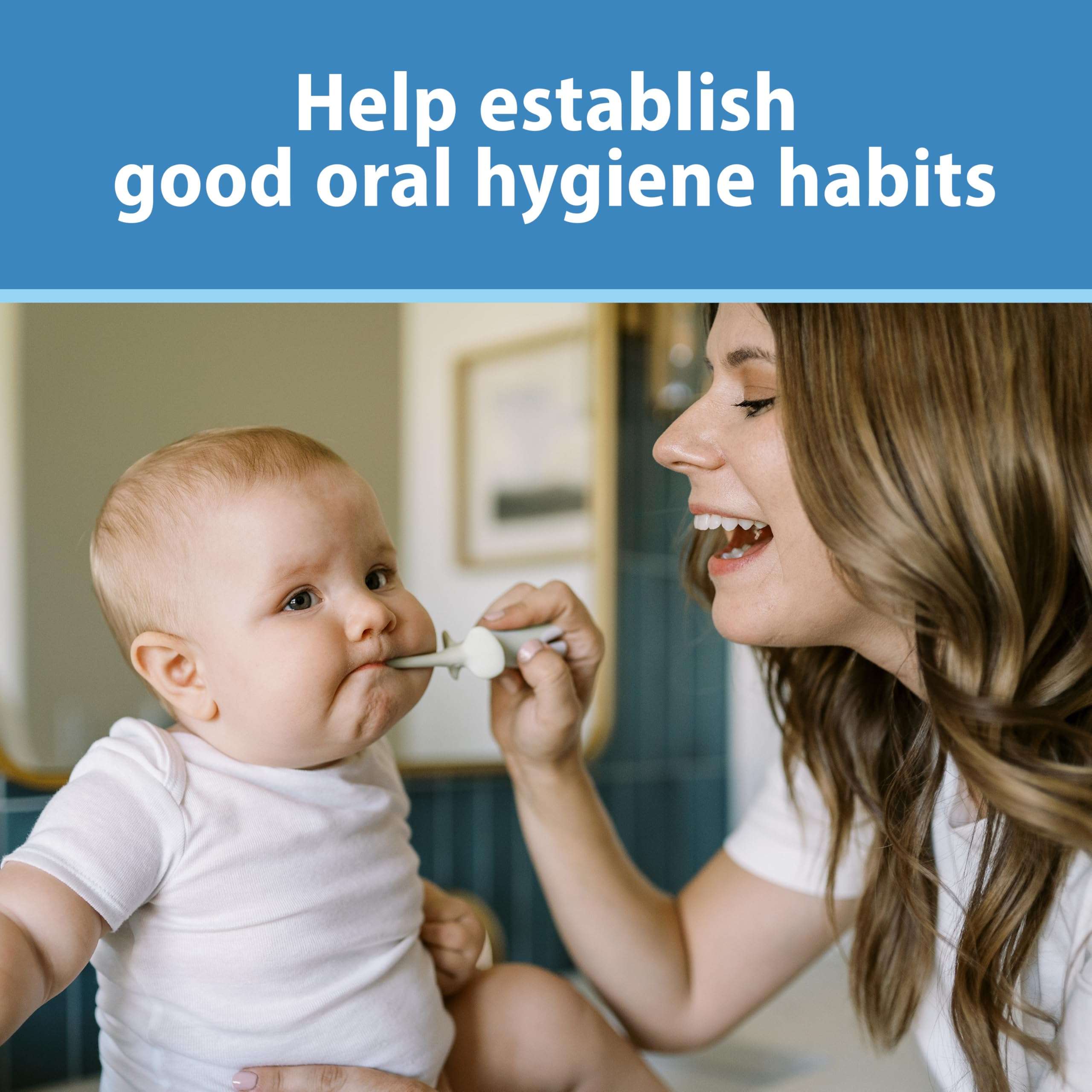 Dr. Brown's infant toothbrush 0-3 years used by a smiling mother gently cleaning a baby's first teeth