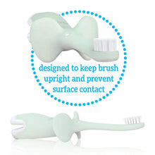 Mint elephant-shaped infant toothbrush with soft bristles, side view for brushing