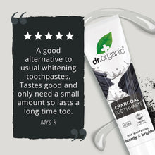 Charcoal toothpaste tube with dr.organic label, white cap and green leaf logo