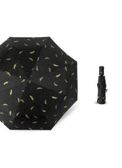 Mumzar black dual purpose automatic umbrella with gold feather pattern shown open and closed