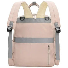 Light pink baby travel backpack front view with gray shoulder straps and side zip pockets.
