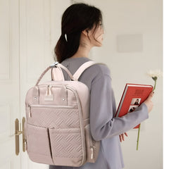 Huitich stylish baby travel bag backpack in light pink with multiple pockets worn by woman