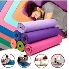 Stacked yoga mats in purple, pink, blue, orange and green