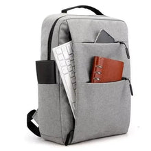 Gray laptop backpack with open front compartment holding a notebook and cards.