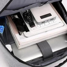 Inside view of gray laptop backpack with laptop, cards, and organizer straps.