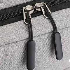 Close-up of durable laptop backpack waterproof gray fabric with black zipper pulls by Huitich