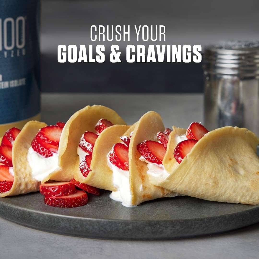 Dymatize ISO 100 whey protein UAE with strawberry cream crepes on plate and shaker bottle in background