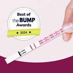 easy at home pregnancy kit showing positive HCG test strip held by hand with Best of the BUMP 2024 badge