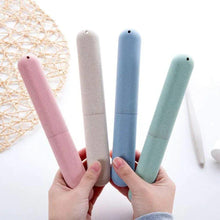 Travel toothbrush storage cases held in hand, pink, beige, blue, and green