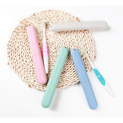 NEXCURIO travel toothbrush case set in pastel pink mint blue and beige with two toothbrushes on woven mat