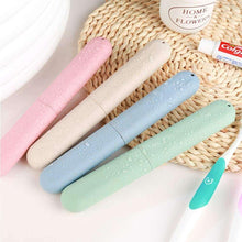 Travel toothbrush storage cases with toothbrushes, pink, beige, blue, and green