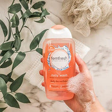 Femfresh daily wash gel cleanser bottle in hand, orange cap, soap-free, 250ml