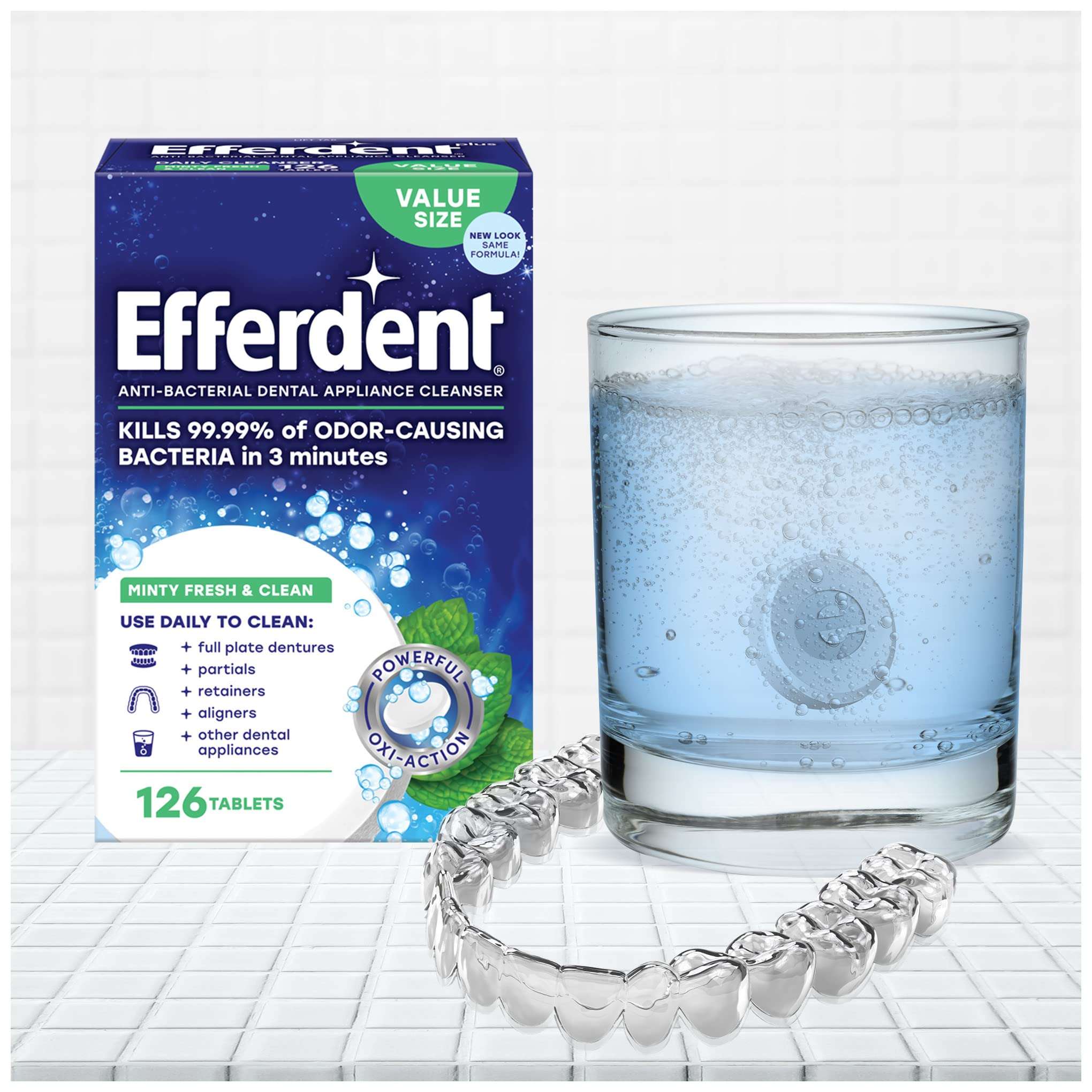 Box of Efferdent mint fresh dental cleaner with effervescing tablet in glass and clear dental tray