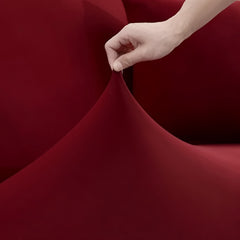 Huitich elastic sofa slipcover for armchair in red being stretched by hand showing flexible fabric