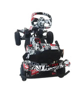 Kids electric go kart with safety harness, front view, black/white/red graffiti design