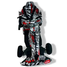 Kids electric go kart with safety harness, upright back view, black/white/red graffiti