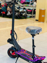 Electric scooter side view with seat, purple deck graphics and red front wheel