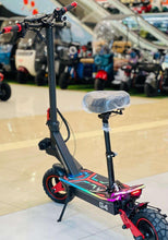 Electric scooter with padded seat cover and purple deck, red wheel rims