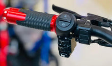 Electric scooter handlebar with red throttle cover and control buttons on black housing.