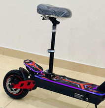 Electric scooter with padded seat and blue-purple deck graphics on black frame.