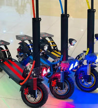 Electric scooter with blue frame, red front suspension, and LED headlight accents