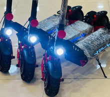 Electric scooter front and deck with bright white headlight, blue fenders, black tires