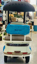 Rear view of electric 3-wheel tricycle with blue cover and black canopy, beige body