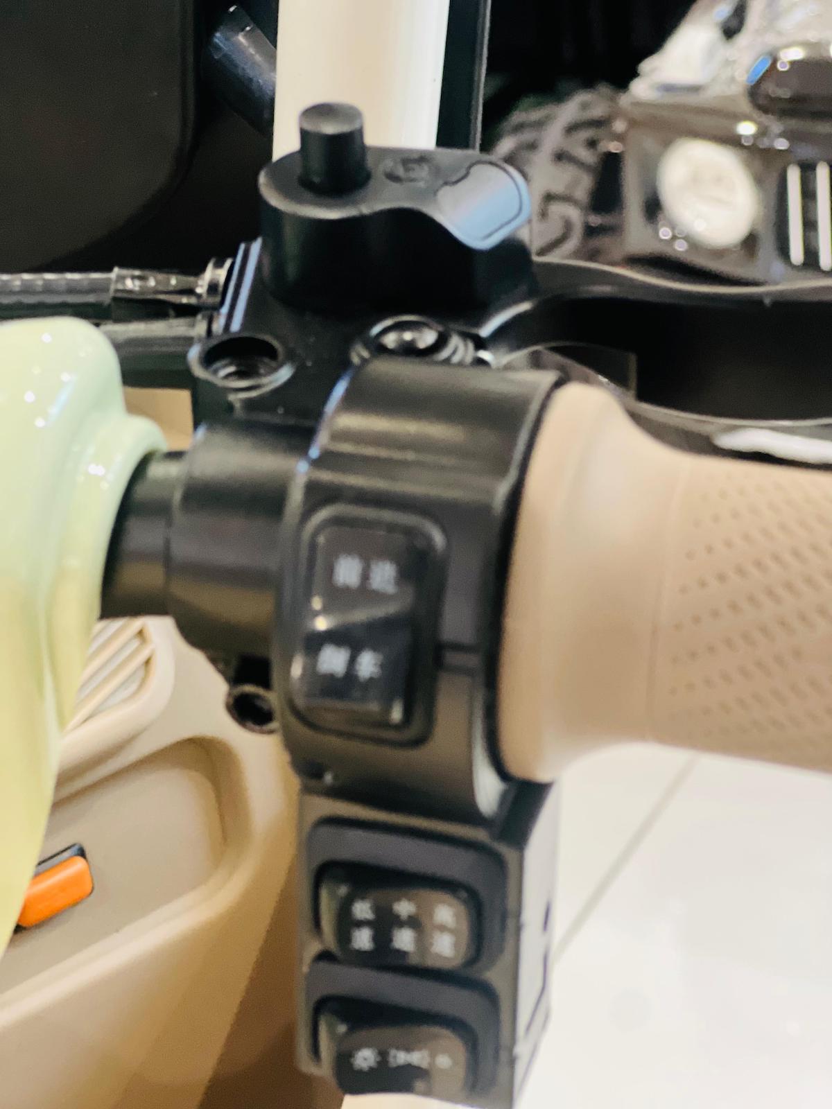 Close-up of controls on Rohan Wings electric tricycle UAE, showcasing handlebars and buttons for easy navigation