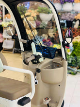 Electric 3-wheel tricycle open side view with brown seats, beige body and armrests