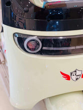 Front headlight and emblem of electric 3-wheel tricycle with beige body