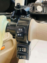Electric tricycle handlebar button panel with protective black housing