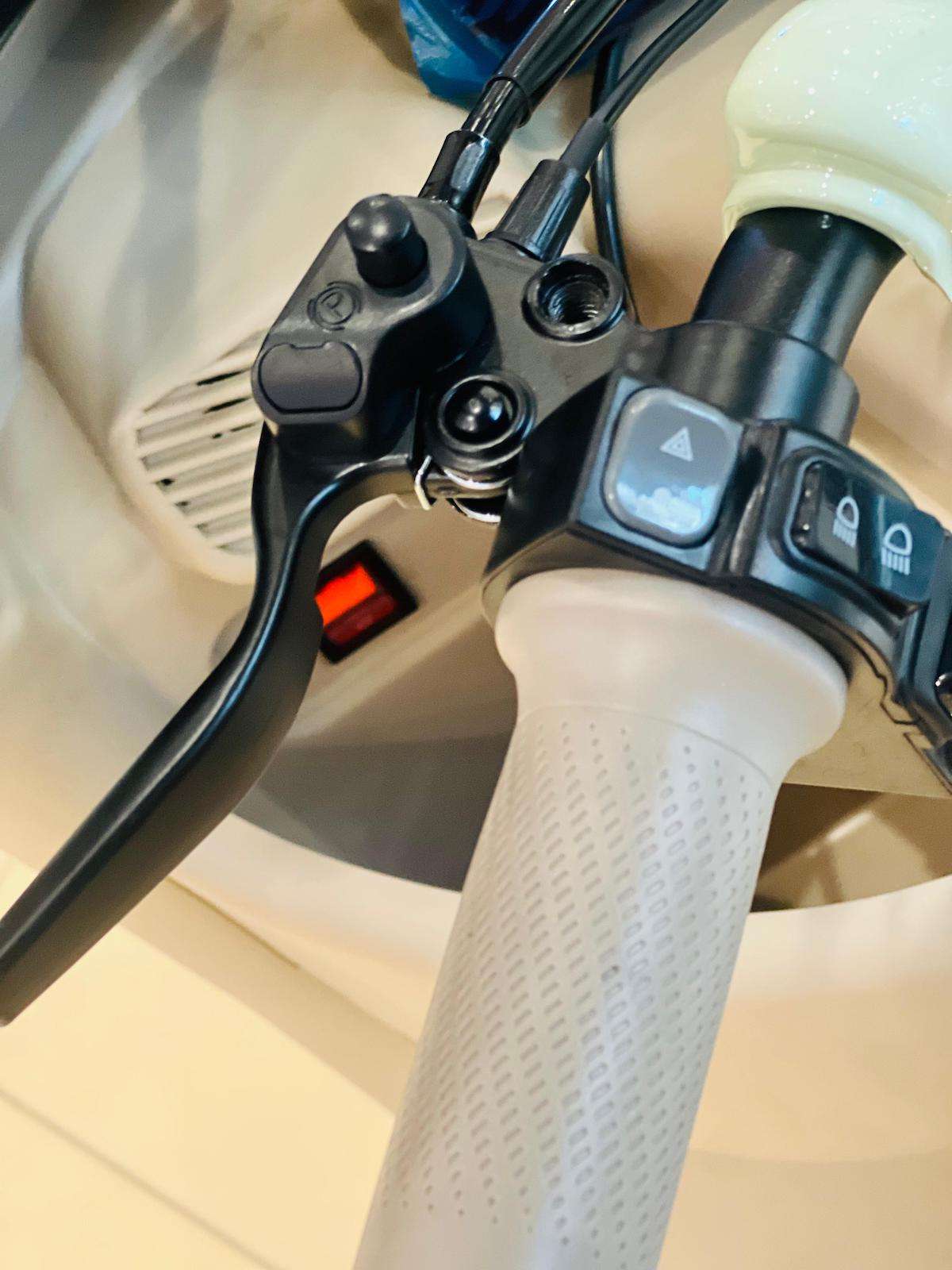 Close-up of Rohan Wings electric tricycle UAE handlebar controls and brakes