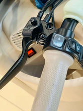 Electric tricycle handlebar control cluster with red rocker switch