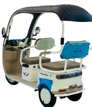 Electric 3-wheel tricycle interior with brown seats, steering controls, beige body