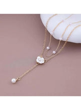 Gold-tone Y-shaped pearl necklace with flower pendant and dangling bead drops