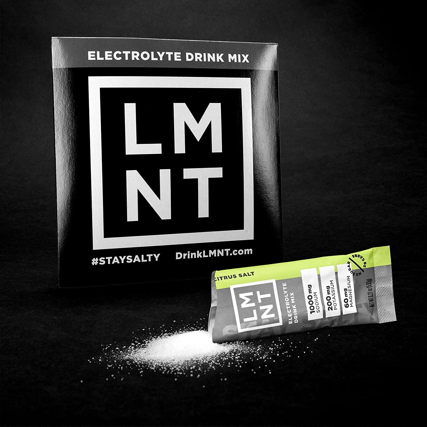 LMNT electrolyte powder UAE citrus salt sachet and black LMNT box with spilled white powder
