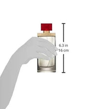 Hand holding red-capped perfume bottle; size shown 6.3 in (16 cm)