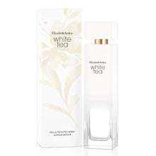 White Eau de Toilette spray bottle with gold cap and matching boxed packaging