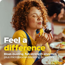 Person eating at a table, curly hair, yellow top, holding food near mouth