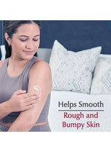 Woman applying Eucerin lotion to her arm; white cream spread on skin.