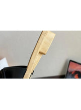 Black wedge sandal with light tan strap, open toe, and gold-edged outsole