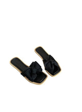 Black wedge sandals with oversized bow straps and open toe, gold-trim sole