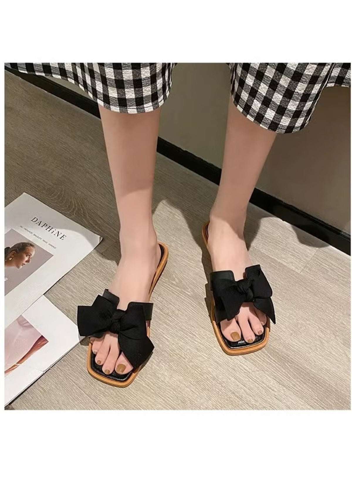 Huitich black fairy style wedge sandals with large bow detail on feet wearing checkered pants