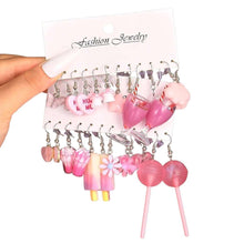 Pink dangle charm earrings set with heart and bear charms on metal hooks