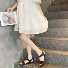 Huitich black open-toe sandals with braided straps and ankle strap, worn on stairs